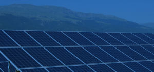 solar array panels with mountains in background
