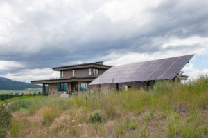 solar array on ground in front of house