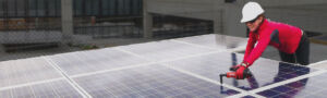 solar installer tightening clamps on solar panels