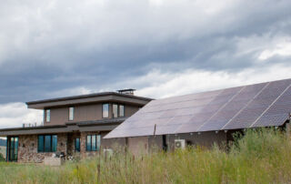 pole mount solar array with home in background