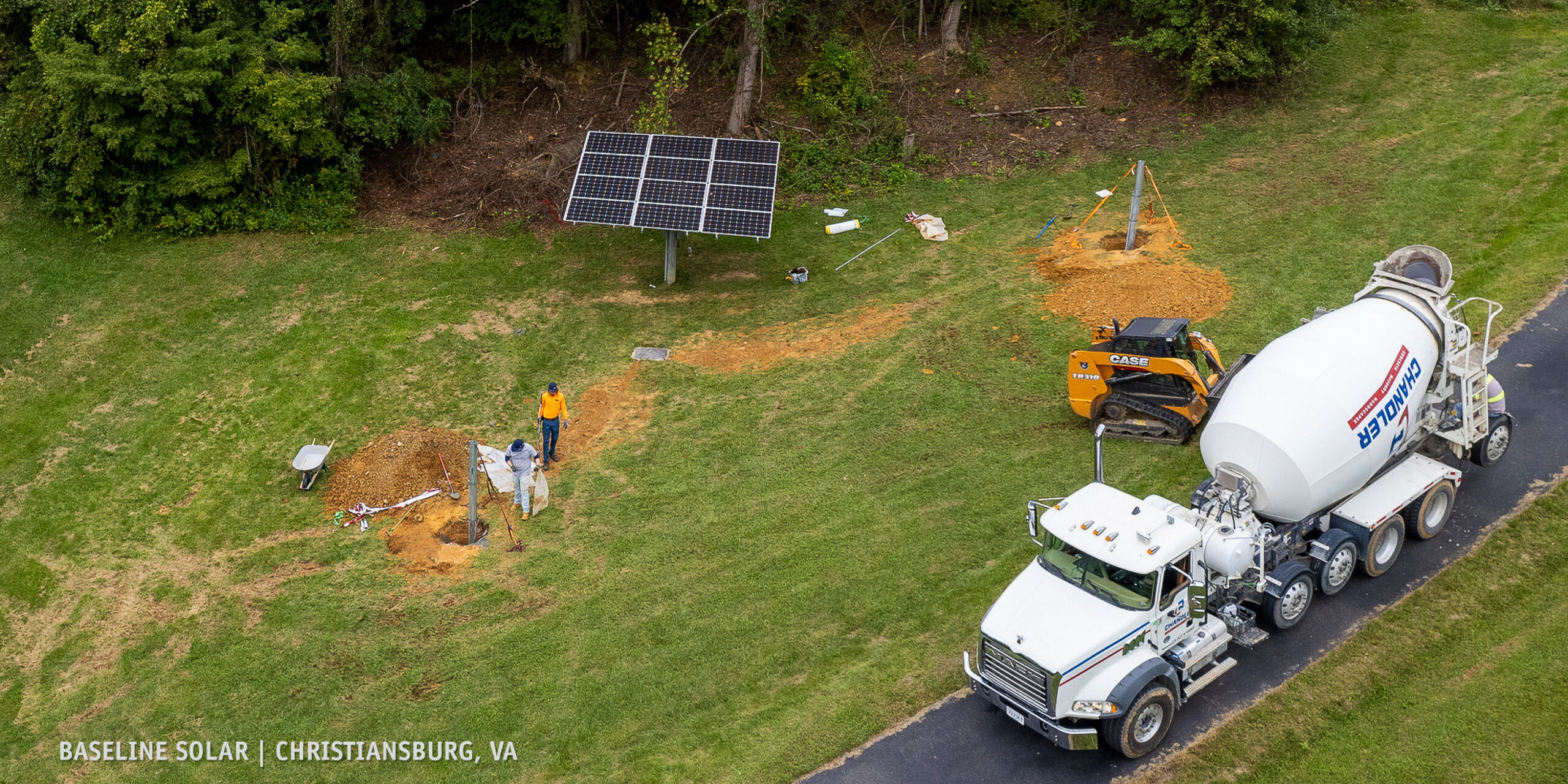 pole mount solar installation from above with concrete truck and installers