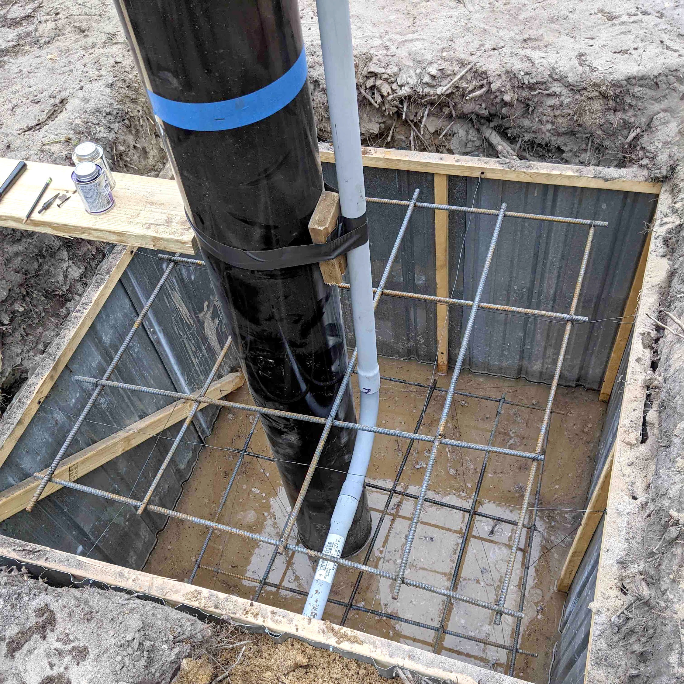 A conduit is placed between the pole and wires for solar mount installation.