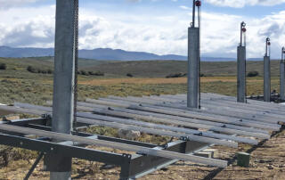 man installing tamarack rails for a ground mounted solar array