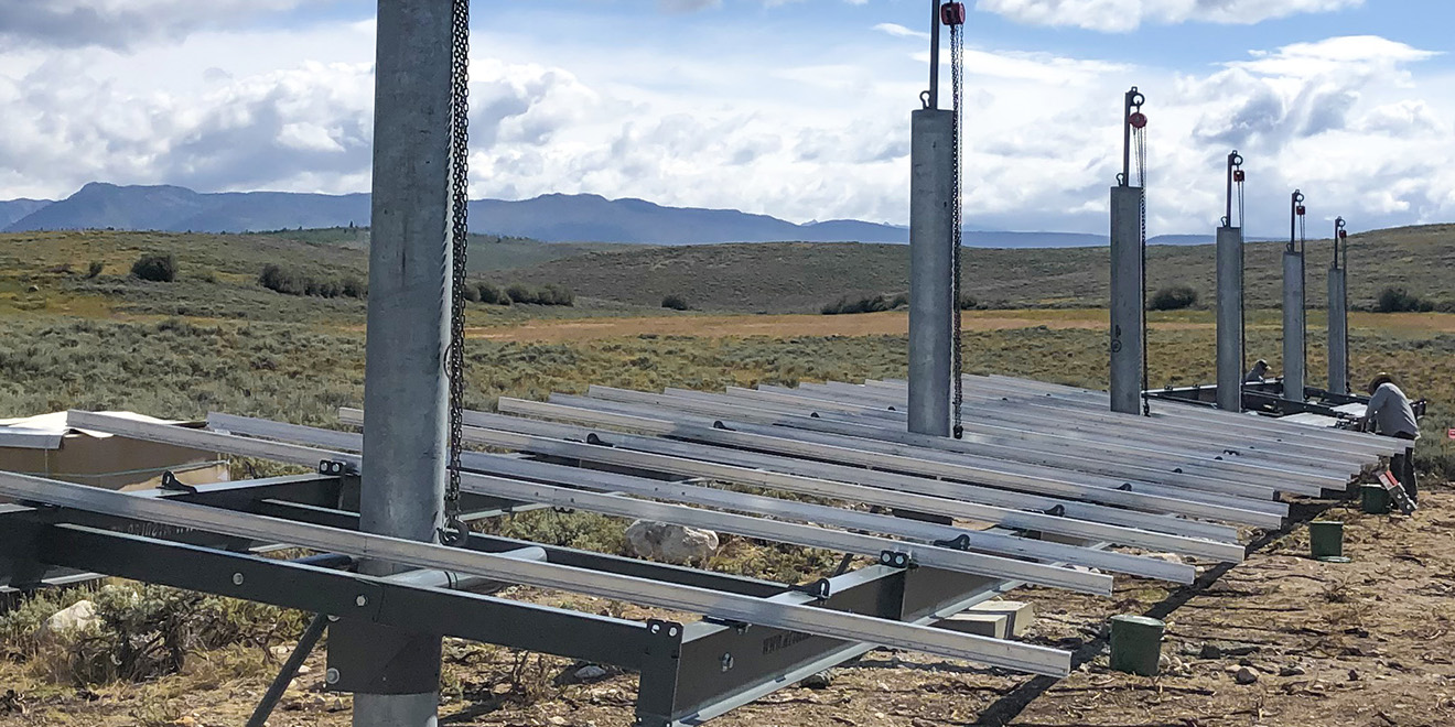 man installing tamarack rails for a ground mounted solar array